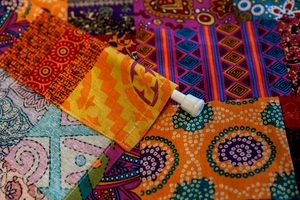 Close-up of bohemian linen door curtain with mandala patterns and tension rod detail