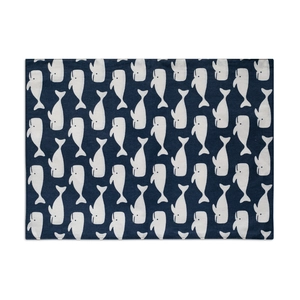 Close-up of bohemian blue placemat with white whale print and woven fabric texture