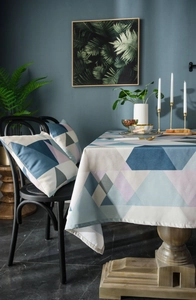 Detail of waterproof Nordic tablecloth and matching pillow with geometric patterns