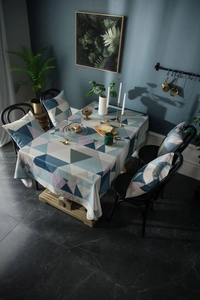 Detail of waterproof Nordic geometric tablecloth set with matching padded chair cushions