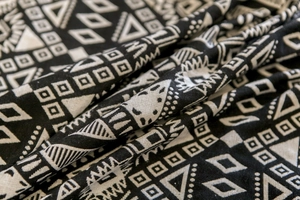 Macro shot of black geometric jacquard pattern on rustic cotton linen kitchen curtain fabric