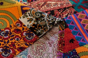 Macro detail of Bohemian linen door curtain featuring vibrant paisley patterns and stitching