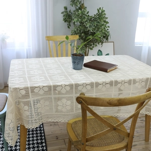Vintage handmade crochet lace tablecloth with geometric patterns and scalloped edges