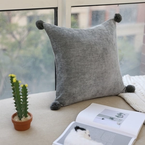 Nordic light grey velvet square throw pillow with four dark grey decorative pom-poms