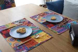 Detailed close-up of Bohemian patterned thick cotton linen placemats on a wooden dining table