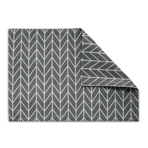 Detailed view of the gray and white herringbone weave fabric and neat edge stitching on the placemat