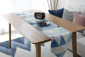 Close-up of waterproof table runner with Nordic blue and pink geometric triangle patterns