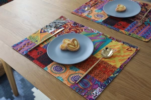 Close-up of Bohemian cotton linen placemat with ethnic patterns on a wooden table