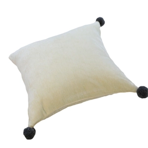 Nordic style velvet square pillow in beige with four dark grey decorative pom-poms