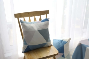 Detail of waterproof Nordic tablecloth showing geometric triangle patterns and fabric texture