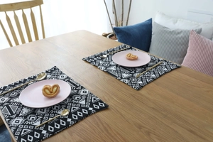 Detailed close-up of double-sided jacquard placemats with black and white geometric patterns
