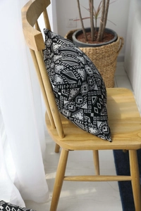 Detail of bohemian geometric pattern on black and white jacquard cushion cover