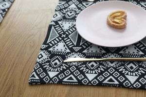 Detail of Nordic geometric jacquard placemat with black and white bohemian pattern fabric