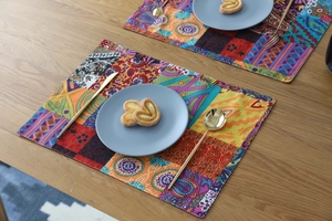 Detailed macro view of bohemian patchwork placemats with mandala patterns and thick fabric texture