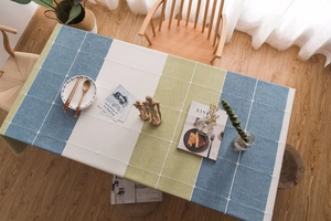 Close-up of Nordic faux linen tablecloth featuring blue and green patchwork with white lace