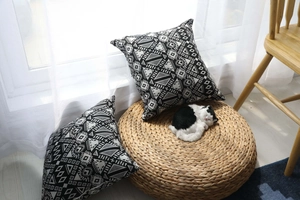 Detail of geometric pattern jacquard cushion cover in black and white ethnic style