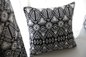Close-up of geometric tribal patterns on a black and white woven cotton linen cushion cover