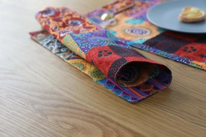 Close-up of bohemian patchwork placemat with paisley patterns on a wooden table