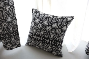 Close-up of geometric jacquard fabric on a black and white ethnic cotton linen cushion
