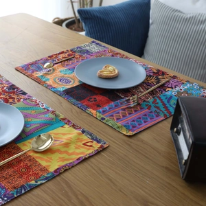 Bohemian style patchwork linen placemat with geometric patterns on a wooden dining table