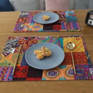 Bohemian style thick cotton linen placemats with colorful ethnic patterns on wooden table
