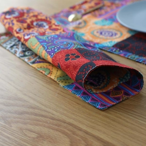 Bohemian cotton linen placemat with colorful patterns on a rustic wooden table