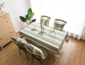 Close-up of Mediterranean blue striped cotton linen tablecloth with tassel fringe detail