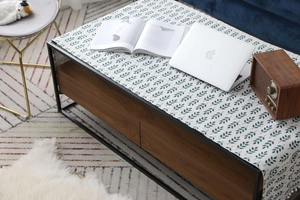 Détail du chemin de table nordique avec motifs de feuilles et pompons décoratifs blancs