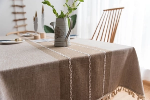 Detail showing high-quality waterproof faux linen tablecloth with white embroidery and tassels