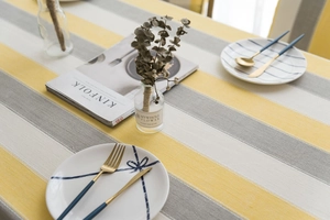 Detail of waterproof striped tablecloth with yellow and grey linen texture for dining tables