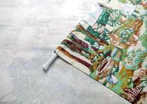 Detail of rod pocket header on floral garden print curtain with white tension rod