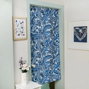 Close-up of Japanese linen curtain with blue floral scroll patterns in a modern home
