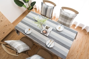 Close-up detail of modern minimalist striped waterproof tablecloth with gray linen texture