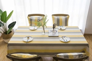 Detailed close-up of yellow and gray striped waterproof tablecloth with high texture fabric