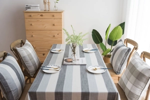 Detail of gray striped waterproof tablecloth with linen texture and Nordic minimalist style