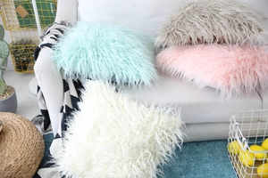 Detail of plush long hair faux sheepskin throw pillow covers in assorted pastel colors