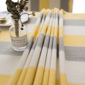 Waterproof striped table runner in yellow, grey, and white with a premium linen texture