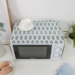 Linen microwave dust cover with blue leaf patterns on white cotton fabric