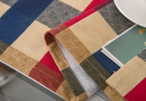 Close-up of neatly stitched rolled edges on a Nordic plaid cotton linen dust cover fabric