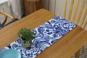 Detailed close-up of blue and white paisley patterns on durable cotton table runner texture