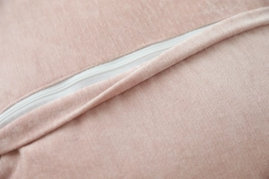 Close-up of pink faux sheepskin pillow cover with a white invisible zipper detail