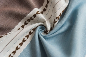 Detail of Nordic table cloth with heart embroidery, lace trim, and faux linen texture