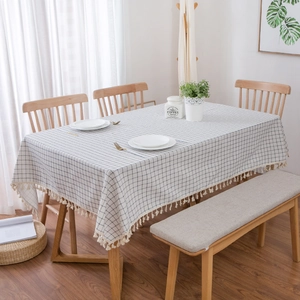 Detailed close-up of Mediterranean plaid tablecloth with cotton linen texture and fringe