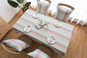 Detailed top view of striped linen tablecloth with pink and blue Nordic style patterns