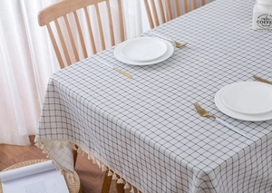 Detailed view of Mediterranean blue checkered linen tablecloth with delicate fringe tassels