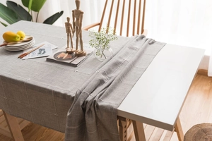 Detail of grey checkered cotton linen tablecloth with premium stitching and natural drape