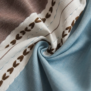 Nordic cotton linen tablecloth featuring blue and brown stitching with tassels and lace