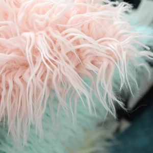 Soft faux sheepskin cushion cover in pastel pink and mint green plush texture