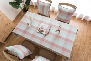 Macro detail of green and pink plaid tablecloth with embroidered lace edging