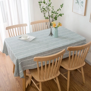 Minimalist light green cotton linen tablecloth with white wave stripes on wooden table